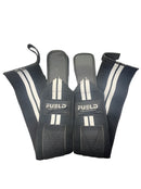 Pair of black wrist wraps with white branding on a dark background