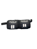 Two black 'FUELD' wrist wraps on a metallic surface