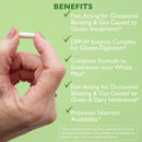 Hand holding a pill with benefits listed on a green background