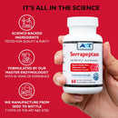 Hand holding a bottle of Serrapeptase supplement with science-themed text on a red background