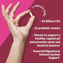 Hand holding a capsule with probiotic product information on a pink background