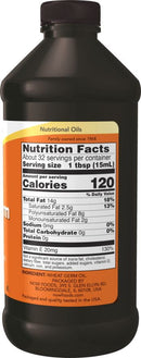Bottle of nutritional oil with a nutrition facts label on an orange background