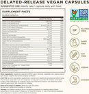 A supplement facts label for delayed-release vegan capsules, with a black-and-white table of nutrients and icons indicating non-GMO verified status, gluten free, dairy free, soy free, vegan, and kosher. The label includes a warning and usage note for adults.