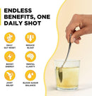 Promotional graphic for a daily supplement, showing a hand holding a metal spoon over a glass of pale yellow liquid. The left side features bold text reading 'ENDLESS BENEFITS, ONE DAILY SHOT' and six yellow circular icons listing benefits like daily gut reset, reduce bloat, boost energy, mental clarity, joint relief, and blood sugar balance.