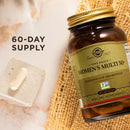 Solgar Women's Multi 50+ supplement bottle with a 60-day supply label on a textured surface.