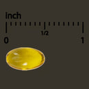 Yellow oval object next to an inch ruler on a black background