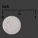 Round concrete sample with a scale indicating measurements in inches on a black background