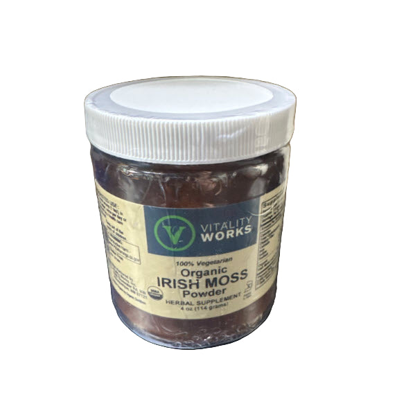 Jar of Vitality Works Organic Irish Moss Powder on a dark surface with a cardboard box in the background.